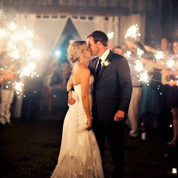 bride and groom kissing with large sparklers 42cm lit around them