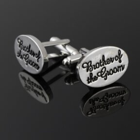 silver oval shaped cufflinks with brother of the groom written in black cursive and debossed into the metal