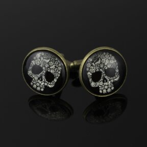 bronze skulls cufflinks. black round cufflinks with a bronze trim and a white decorative skull